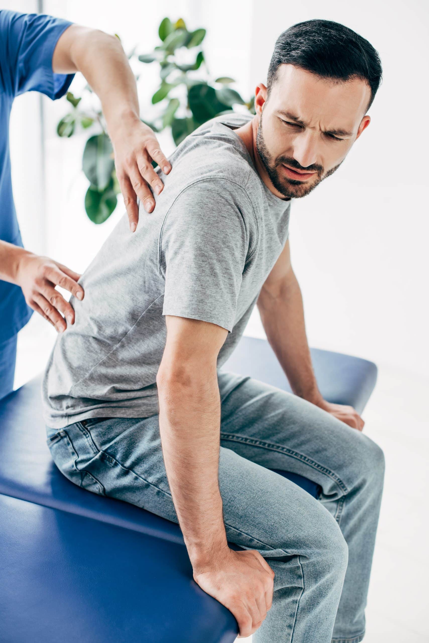 Chiropractor treating a patient's back.