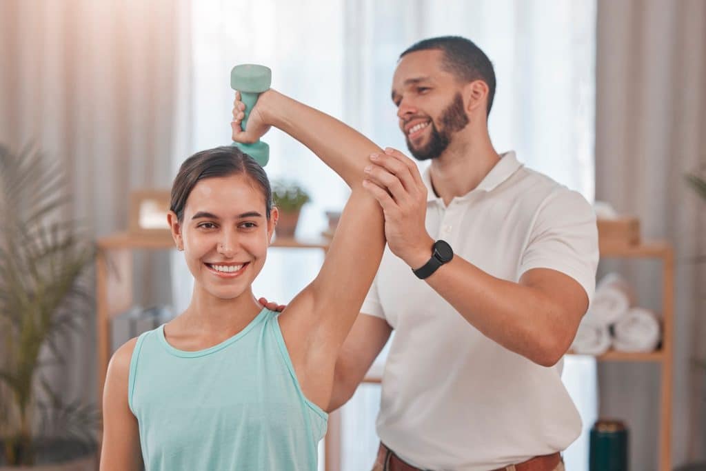 Chiropractor helping patient with shoulder mobility.