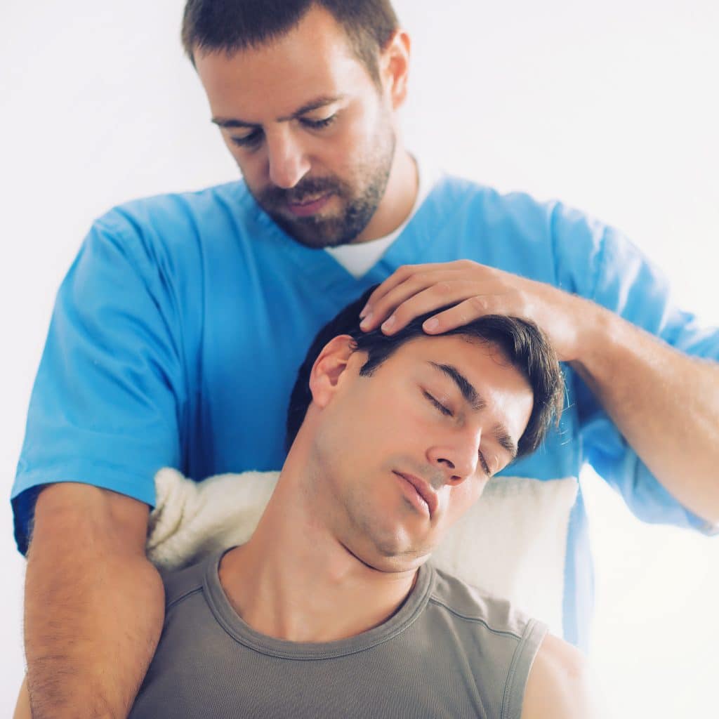 Chiropractor treating a patient's neck after a car accident