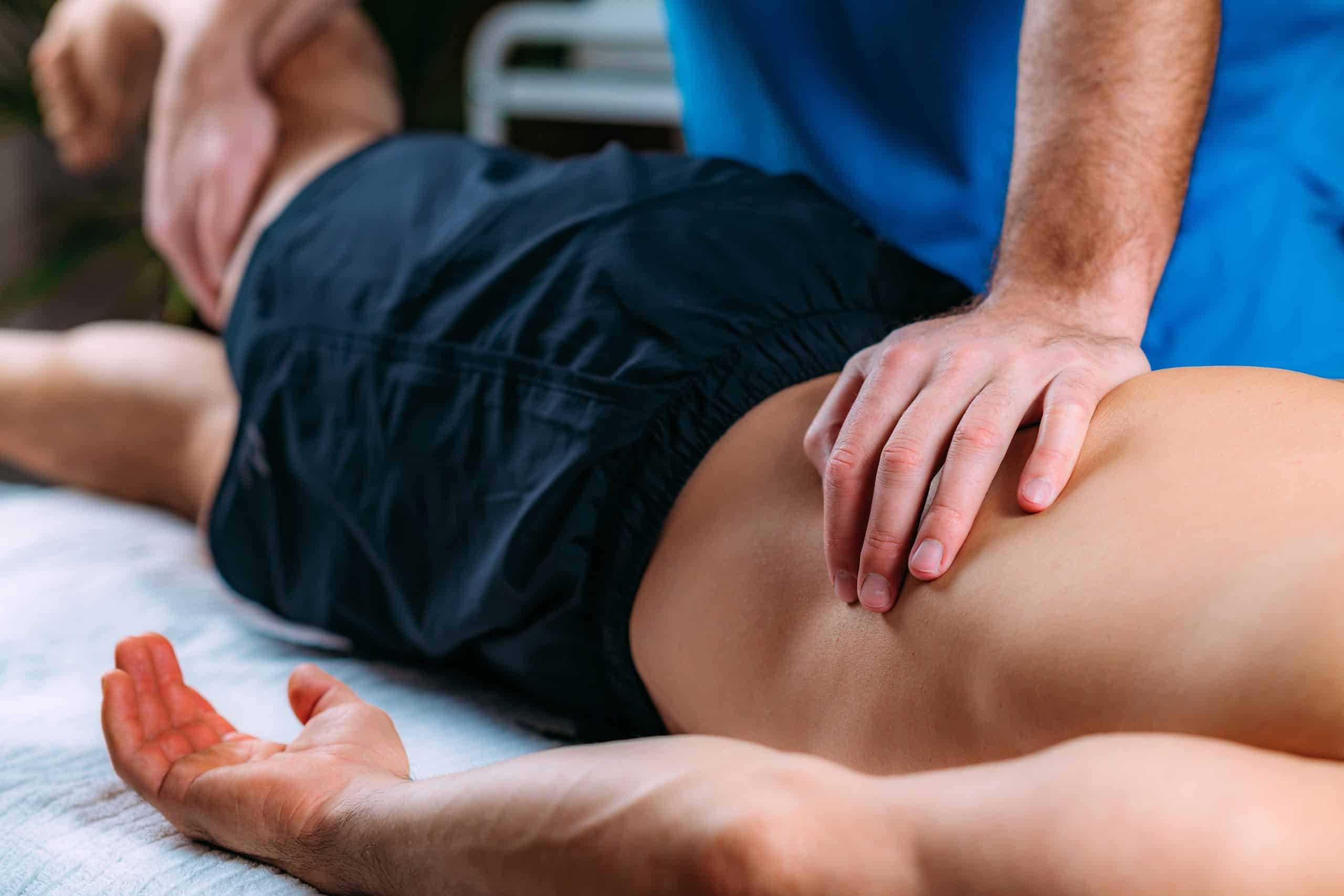 Chiropractor performing a spinal adjustment on a patient