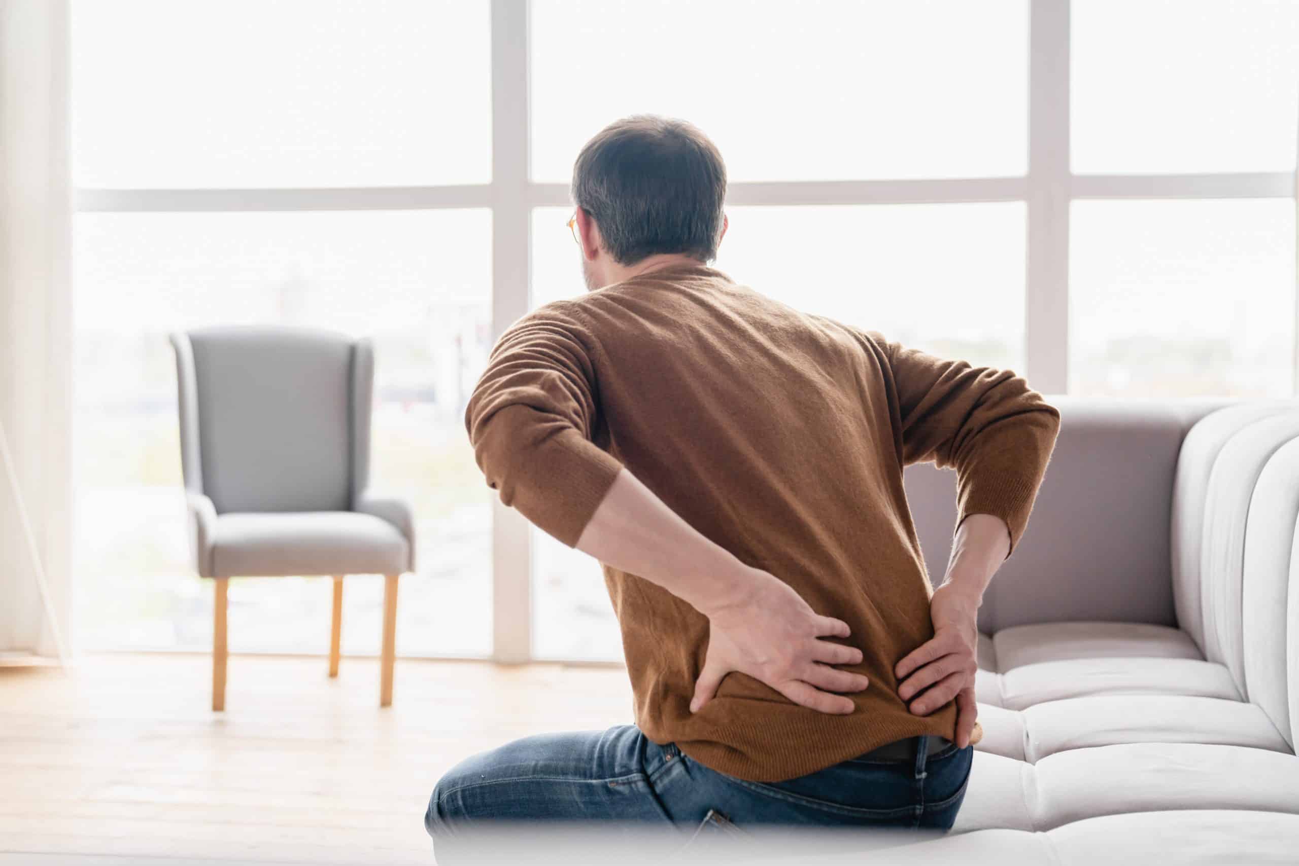 Man holding his lower back in pain