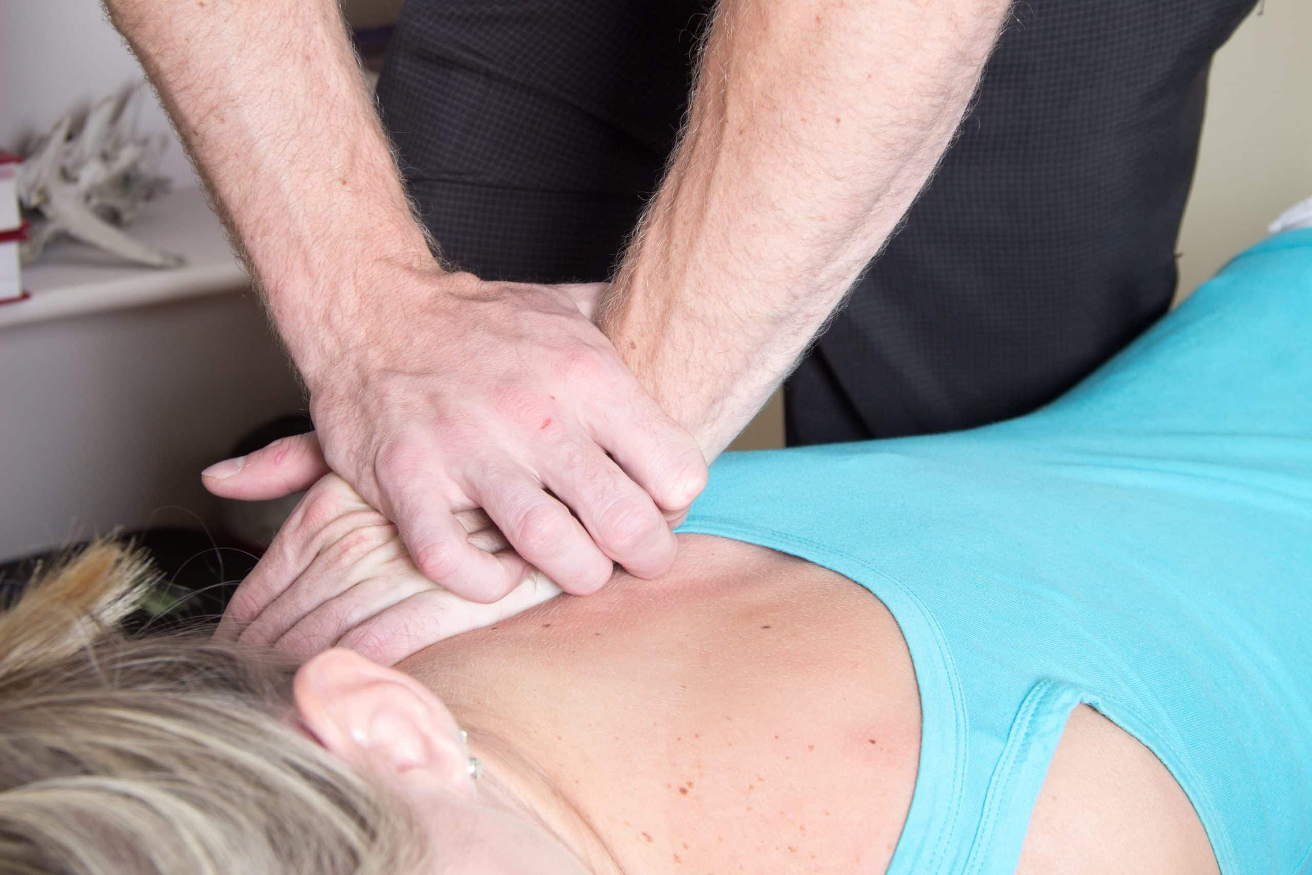 Chiropractor helping to alleviate a woman’s back pain